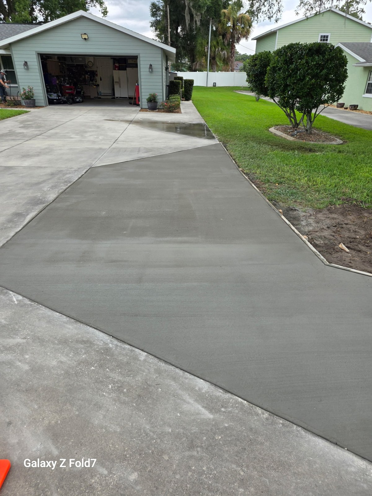 Concrete driveway extension tied into an existing driveway
