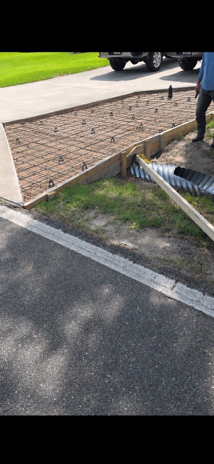 Driveway extension prepared with reinforcing steel and concrete forms
