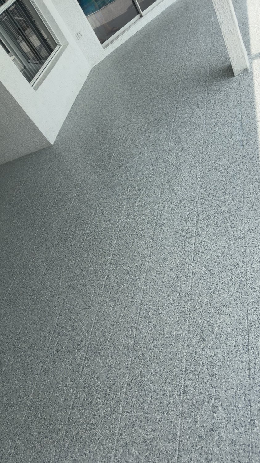 Decorative flake pool deck finish beside a screened patio