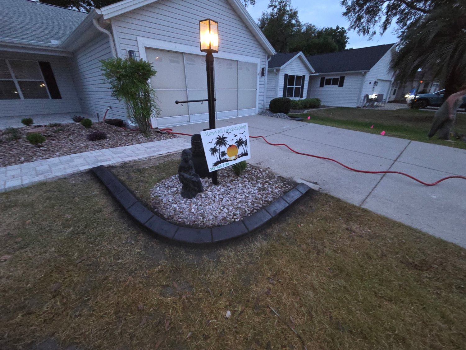Finished front landscape bed with decorative stone and dark border