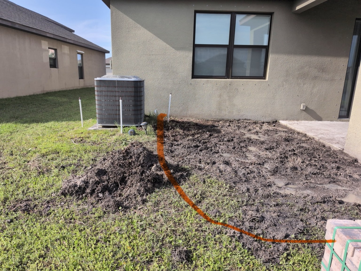 Paver patio installation alongside a covered lanai