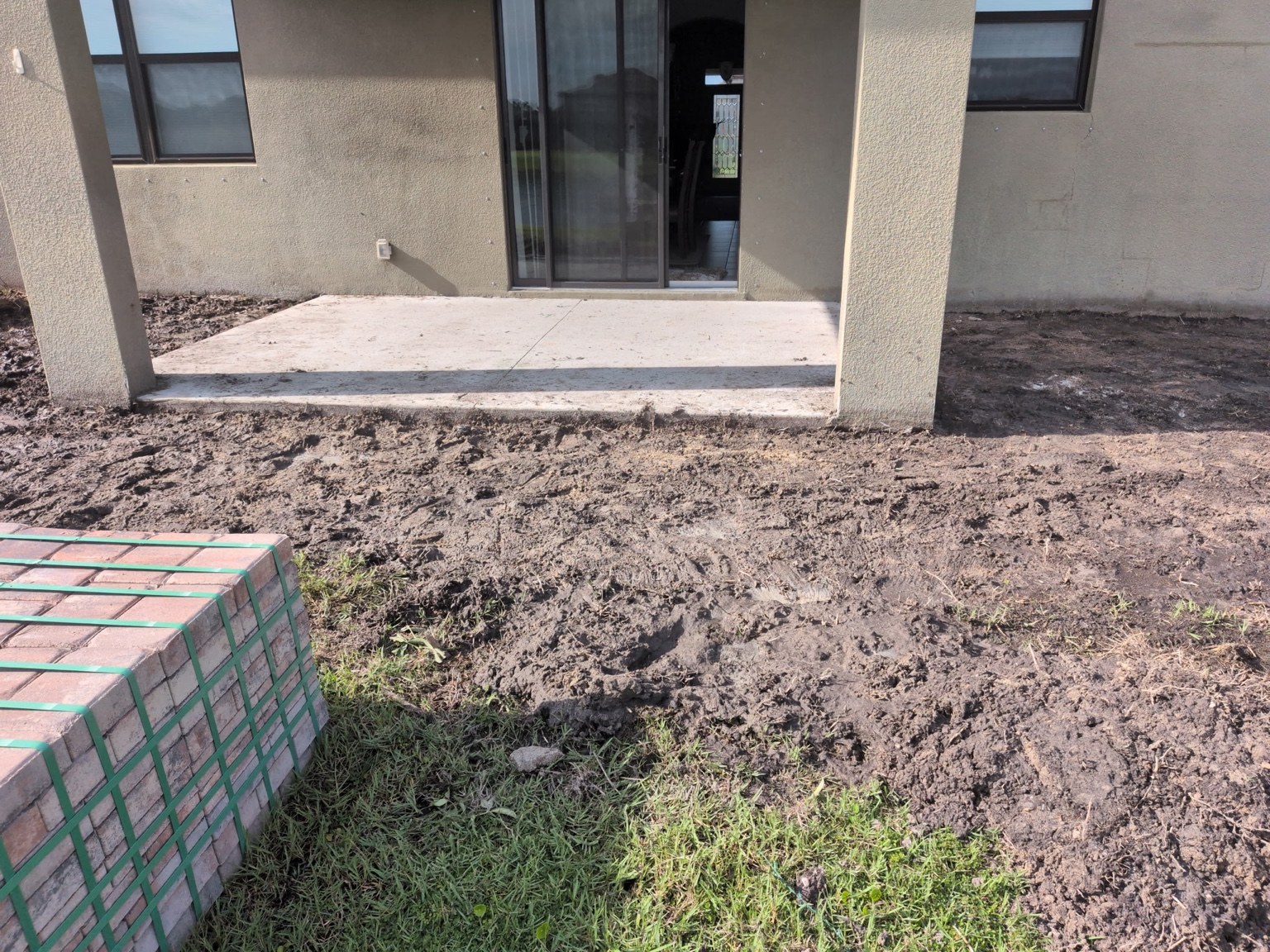 Prepared backyard patio area beside the home