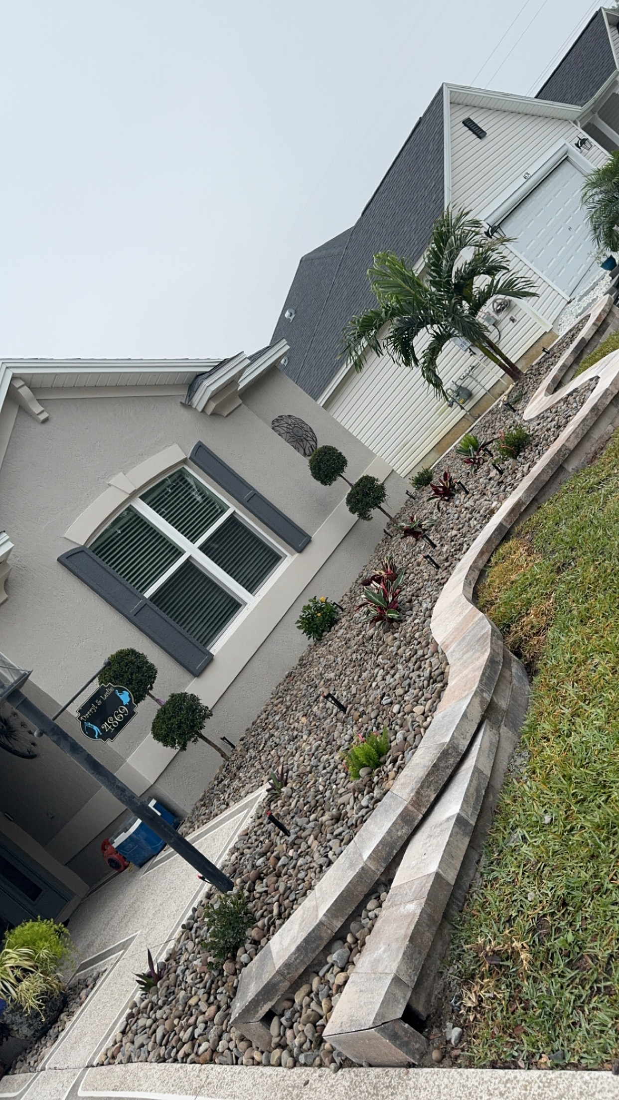 Wide view of completed concrete patio along the back of the home